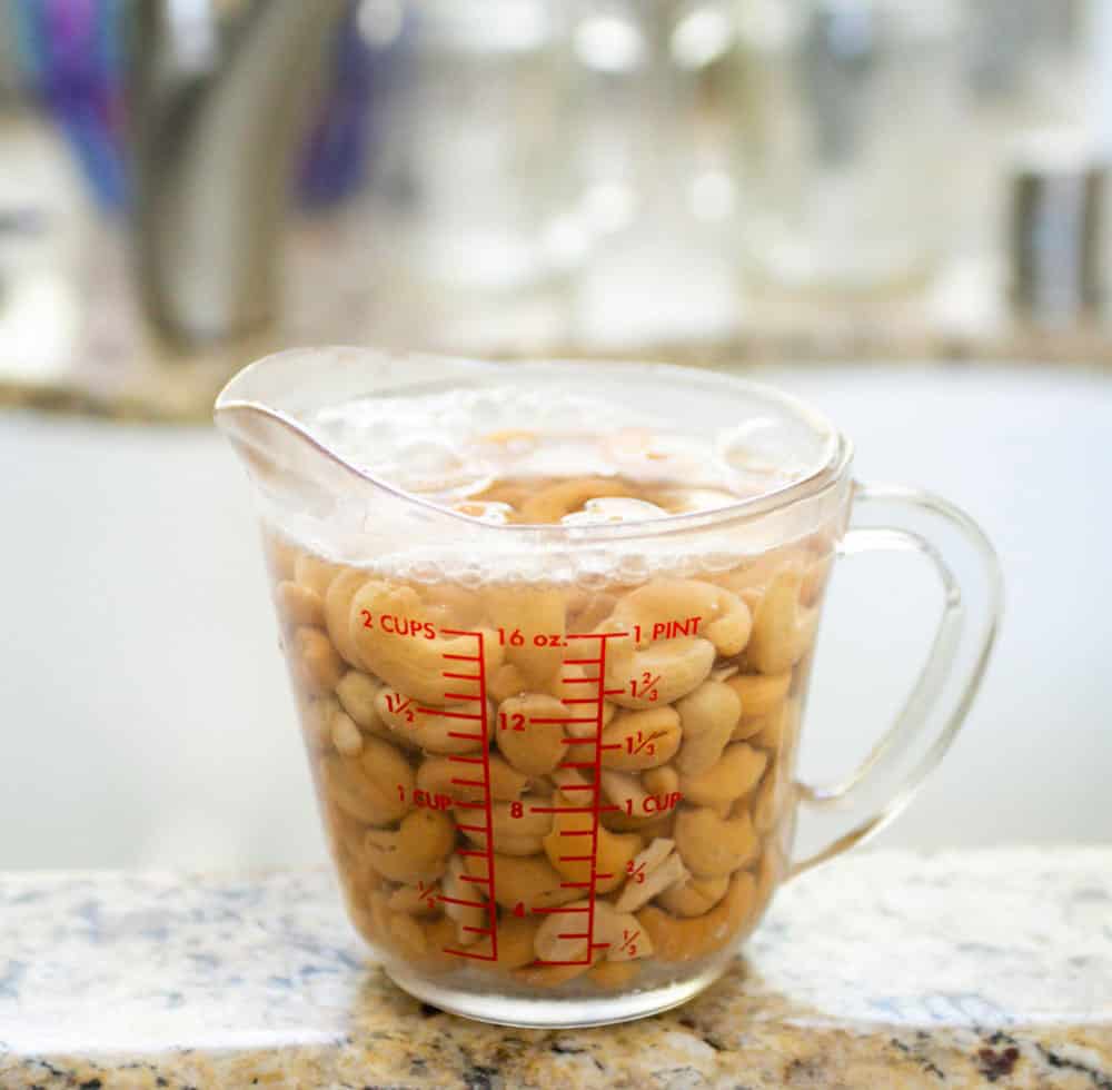 Soak cashews in hot water