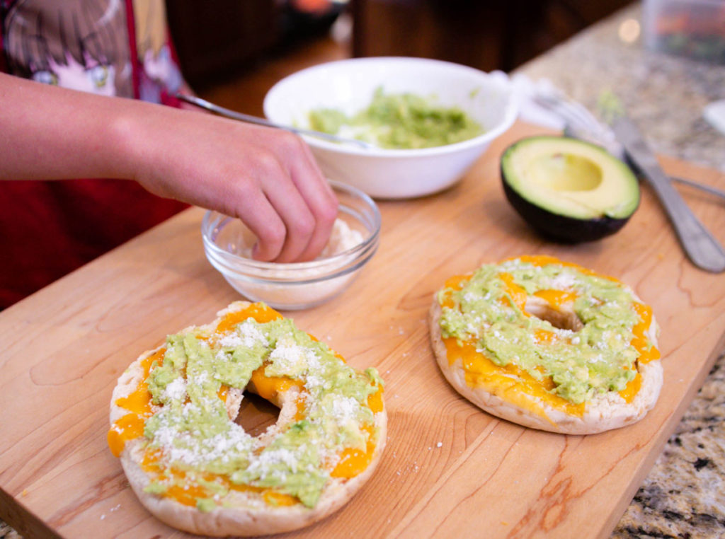 Sprinkle Parmesan onto bagel